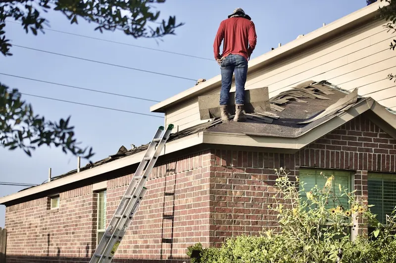 Professional roofer working on a residential roof in James Landing